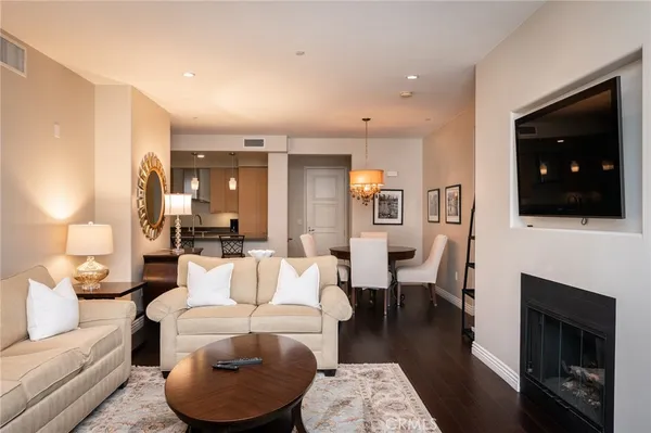 a living room with furniture a flat screen tv and a fireplace