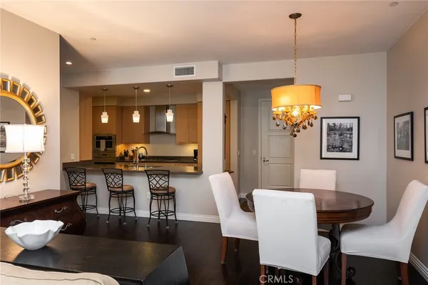 a view of a dining room with furniture and chandelier
