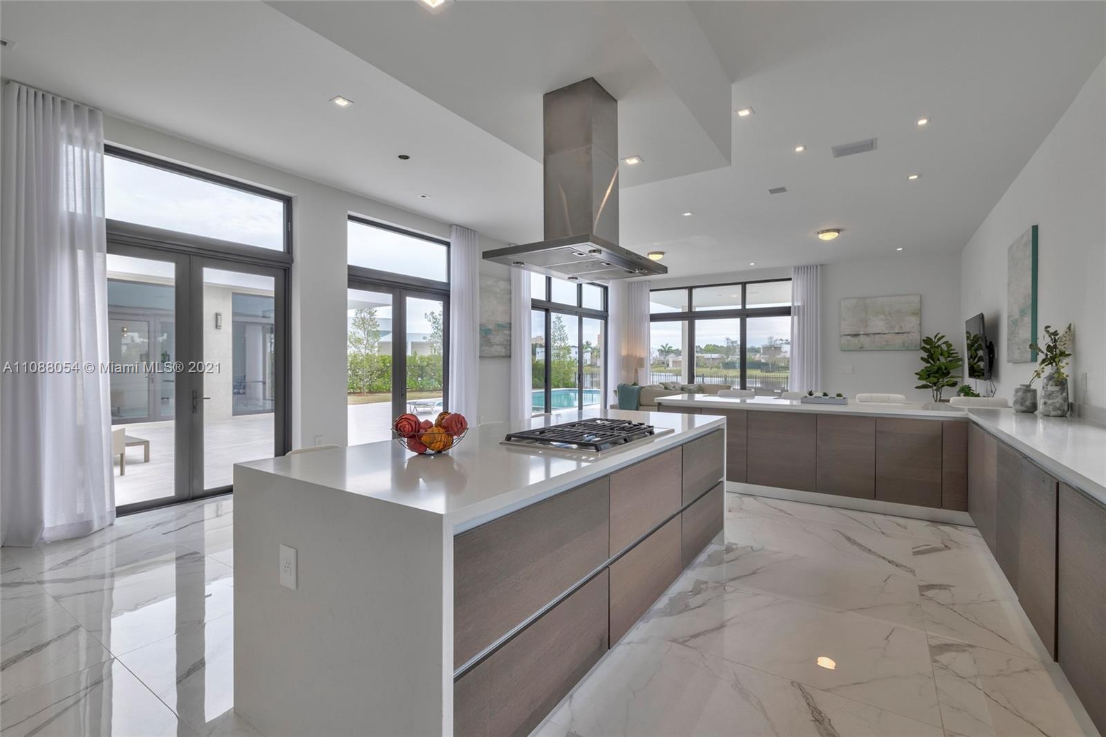 16610 Sunset Way Weston, FL 33326 - Photo 12 of 35 a large white kitchen with a large window