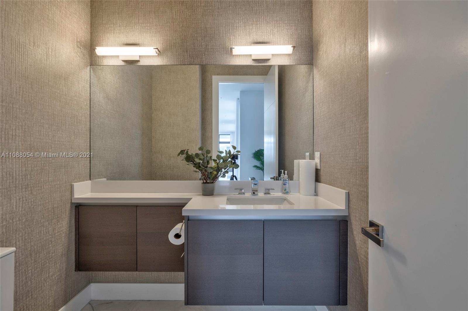 16610 Sunset Way Weston, FL 33326 - Photo 14 of 35 a bathroom with a sink and a mirror