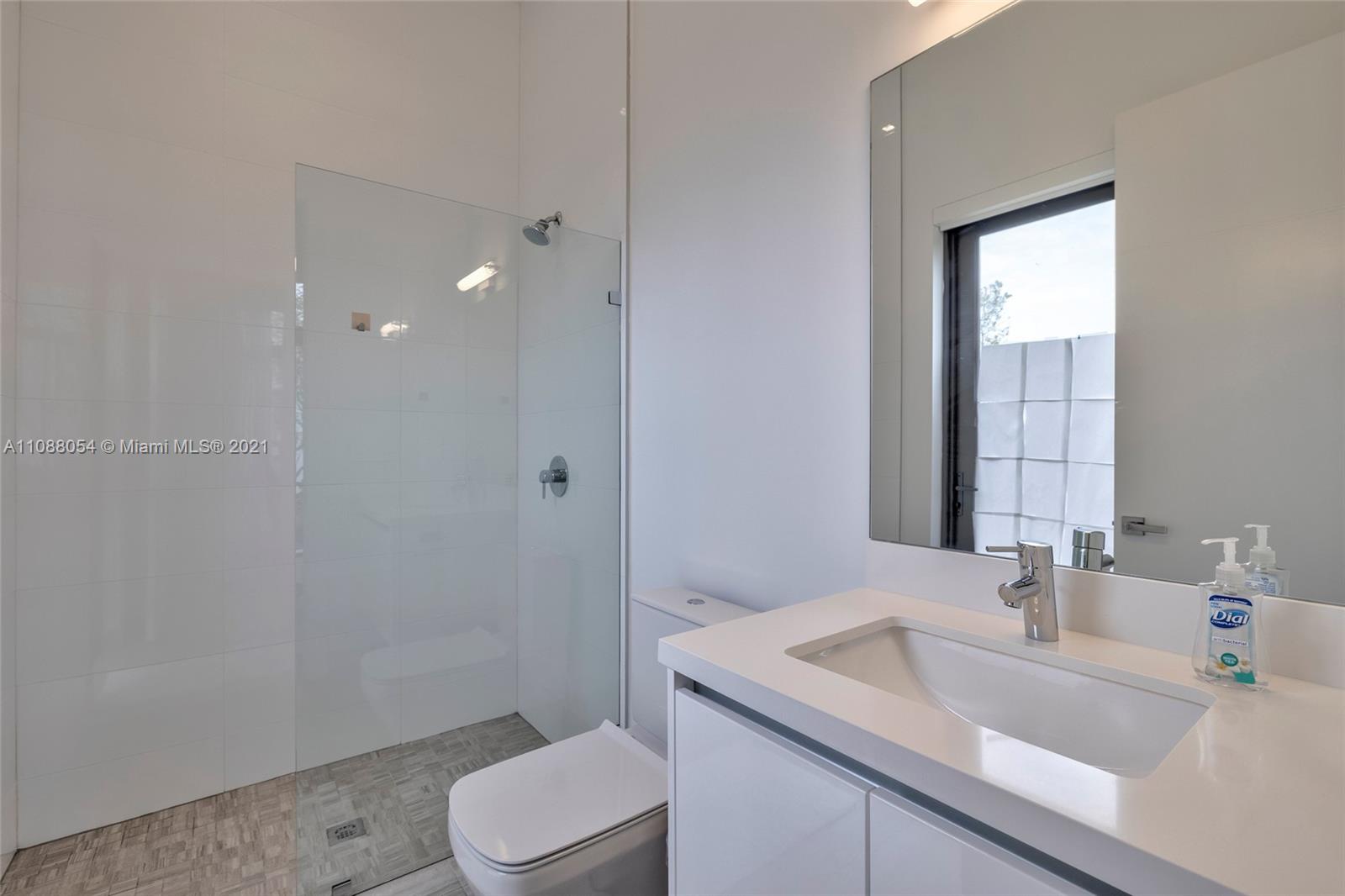 16610 Sunset Way Weston, FL 33326 - Photo 17 of 35 a bathroom with a sink toilet and mirror