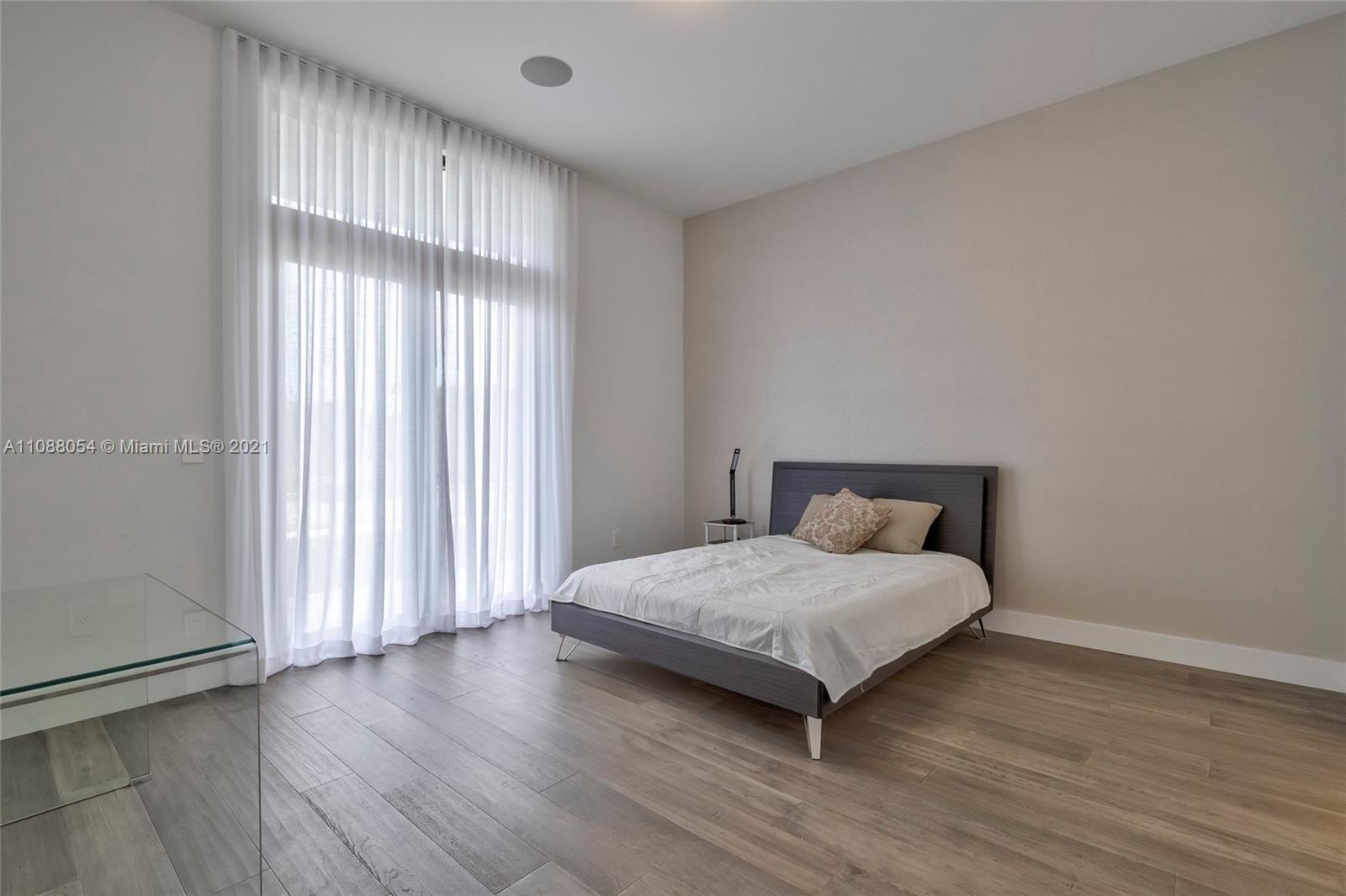 16610 Sunset Way Weston, FL 33326 - Photo 18 of 35 a bedroom with a bed and a window