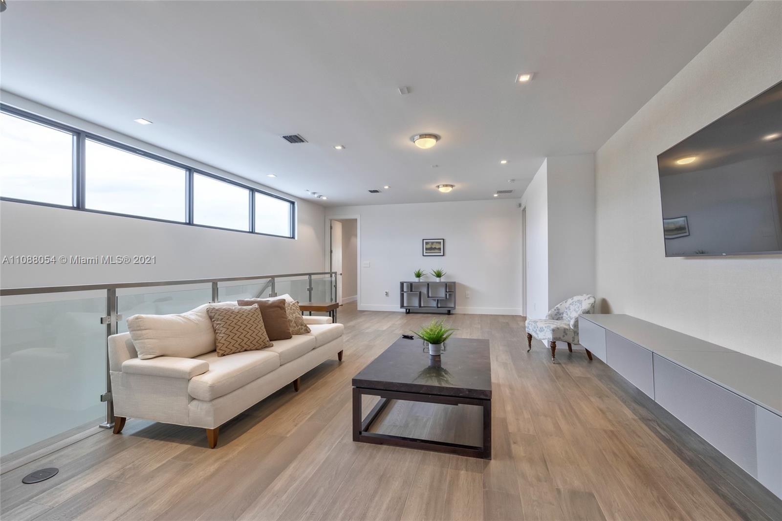 16610 Sunset Way Weston, FL 33326 - Photo 23 of 35 a living room with furniture and a wooden floor