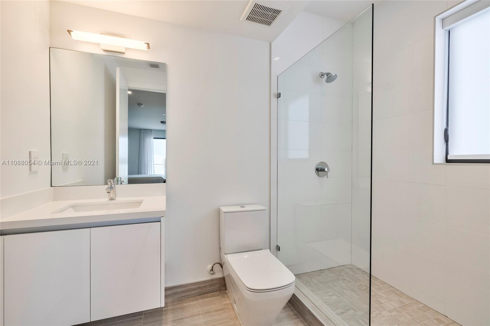16610 Sunset Way Weston, FL 33326 - Photo 25 of 35 a bathroom with a toilet sink shower and mirror
