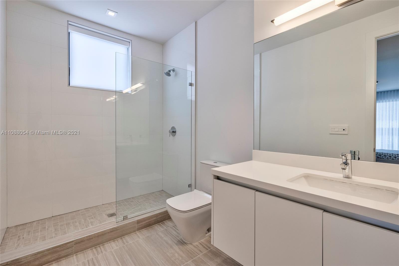 16610 Sunset Way Weston, FL 33326 - Photo 27 of 35 a bathroom with a sink a toilet and shower