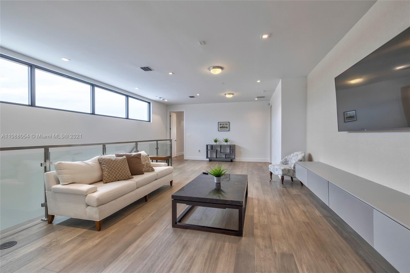 16610 Sunset Way Weston, FL 33326 - Photo 28 of 35 a living room with furniture and a wooden floor