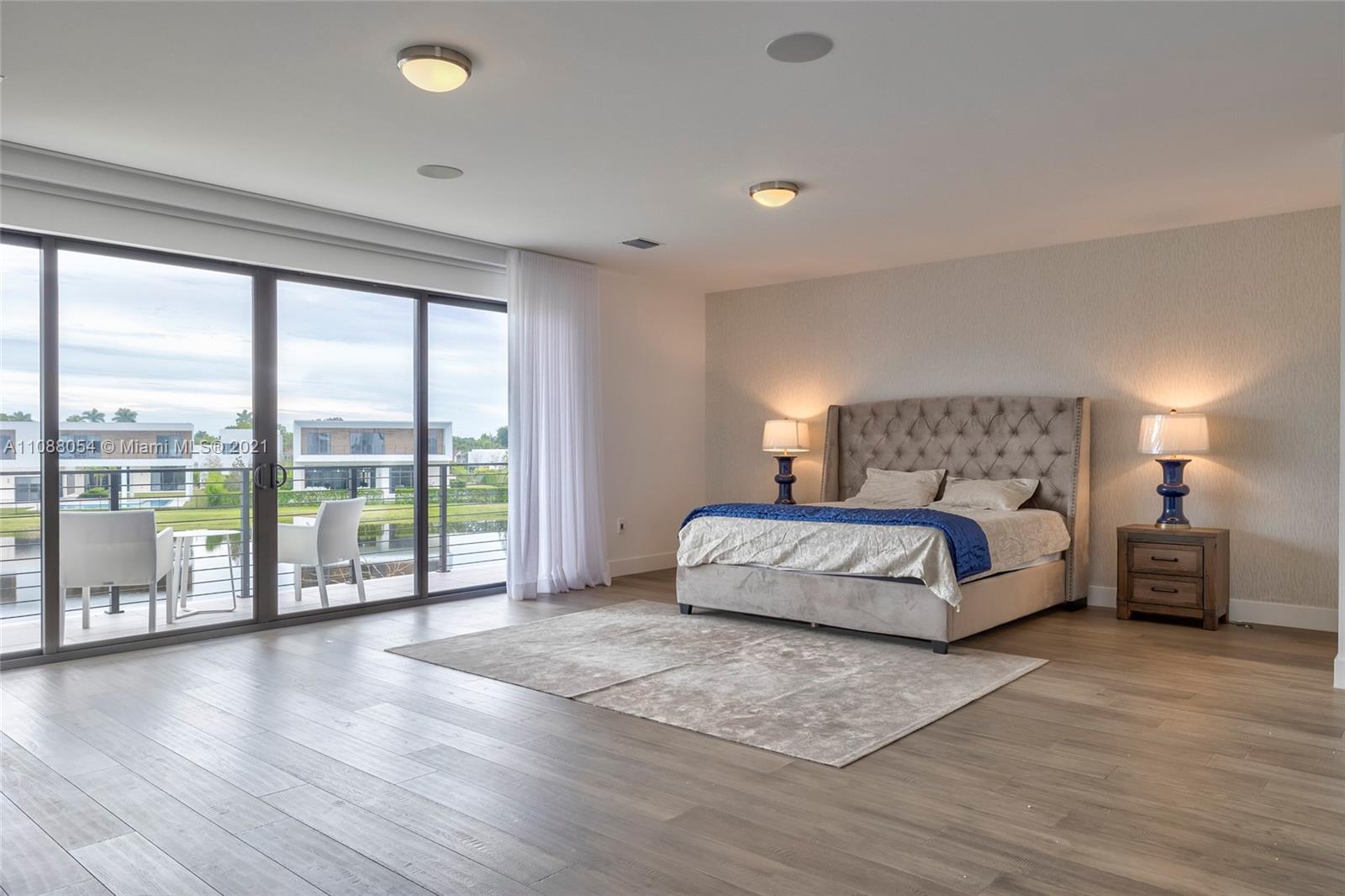 16610 Sunset Way Weston, FL 33326 - Photo 30 of 35 a bedroom with a large bed and a large window