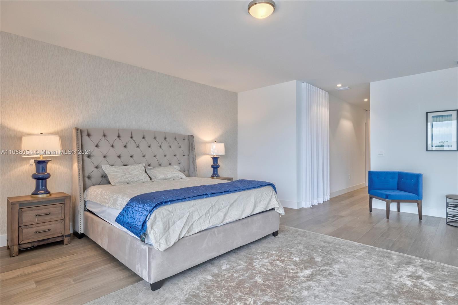 16610 Sunset Way Weston, FL 33326 - Photo 32 of 35 a bedroom with a bed and a chair