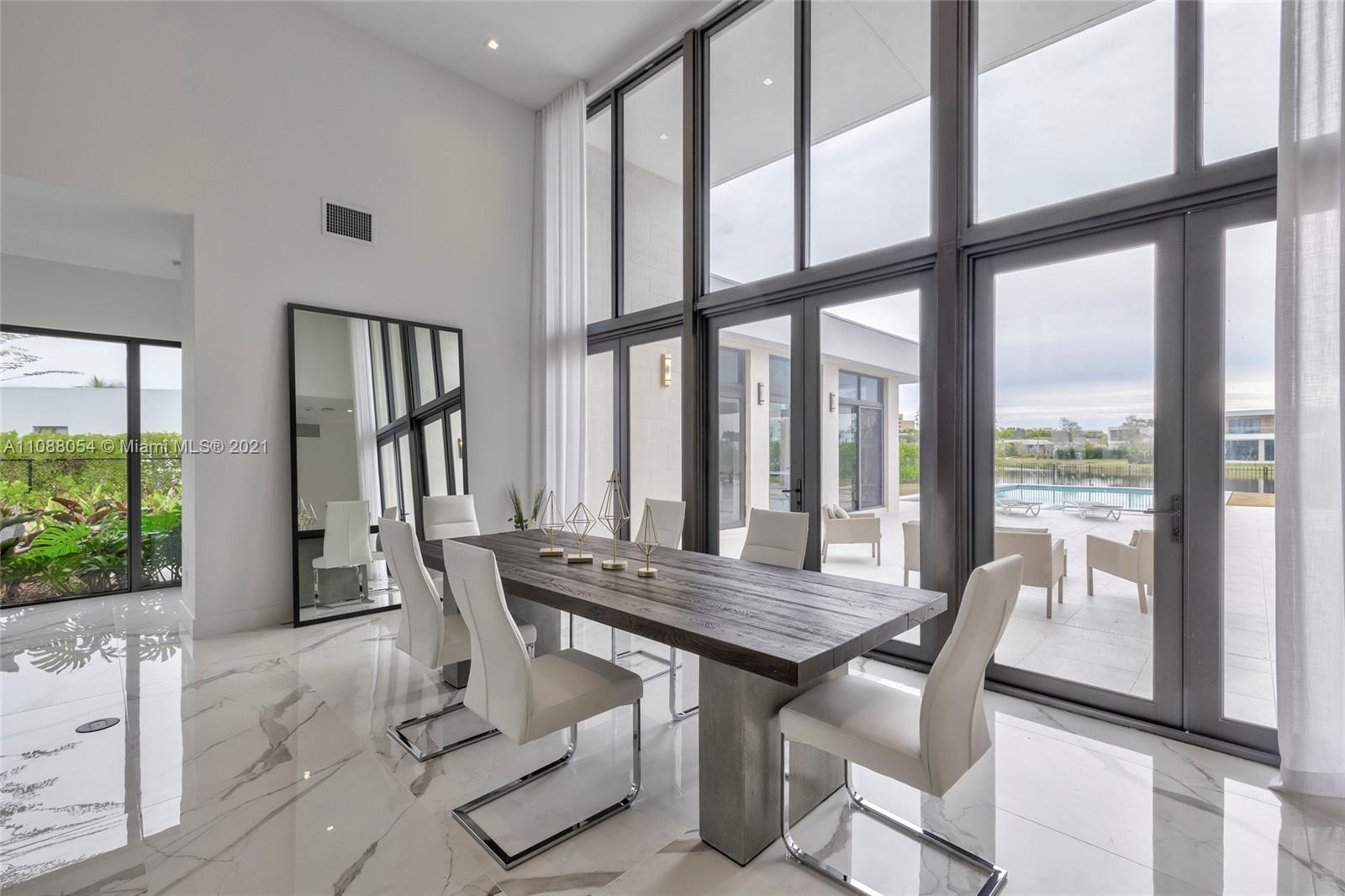 16610 Sunset Way Weston, FL 33326 - Photo 8 of 35 a view of a dining room with furniture large windows and wooden floor