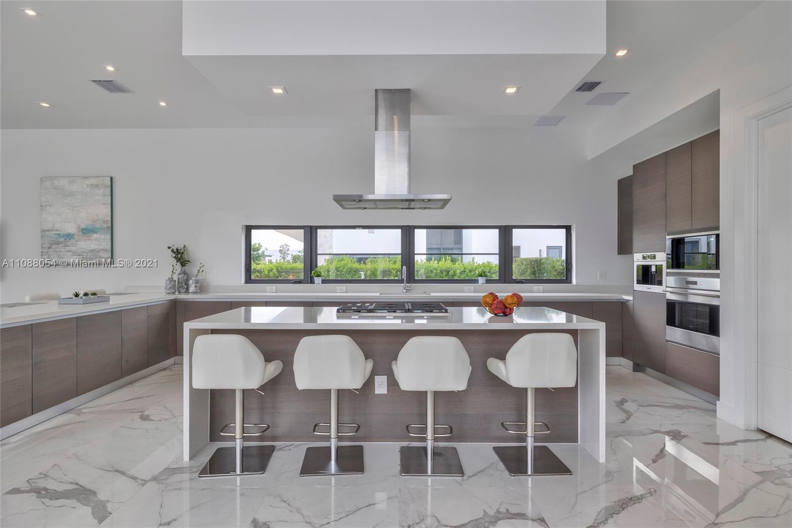 16610 Sunset Way Weston, FL 33326 - Photo 10 of 35 a kitchen with a sink and chairs