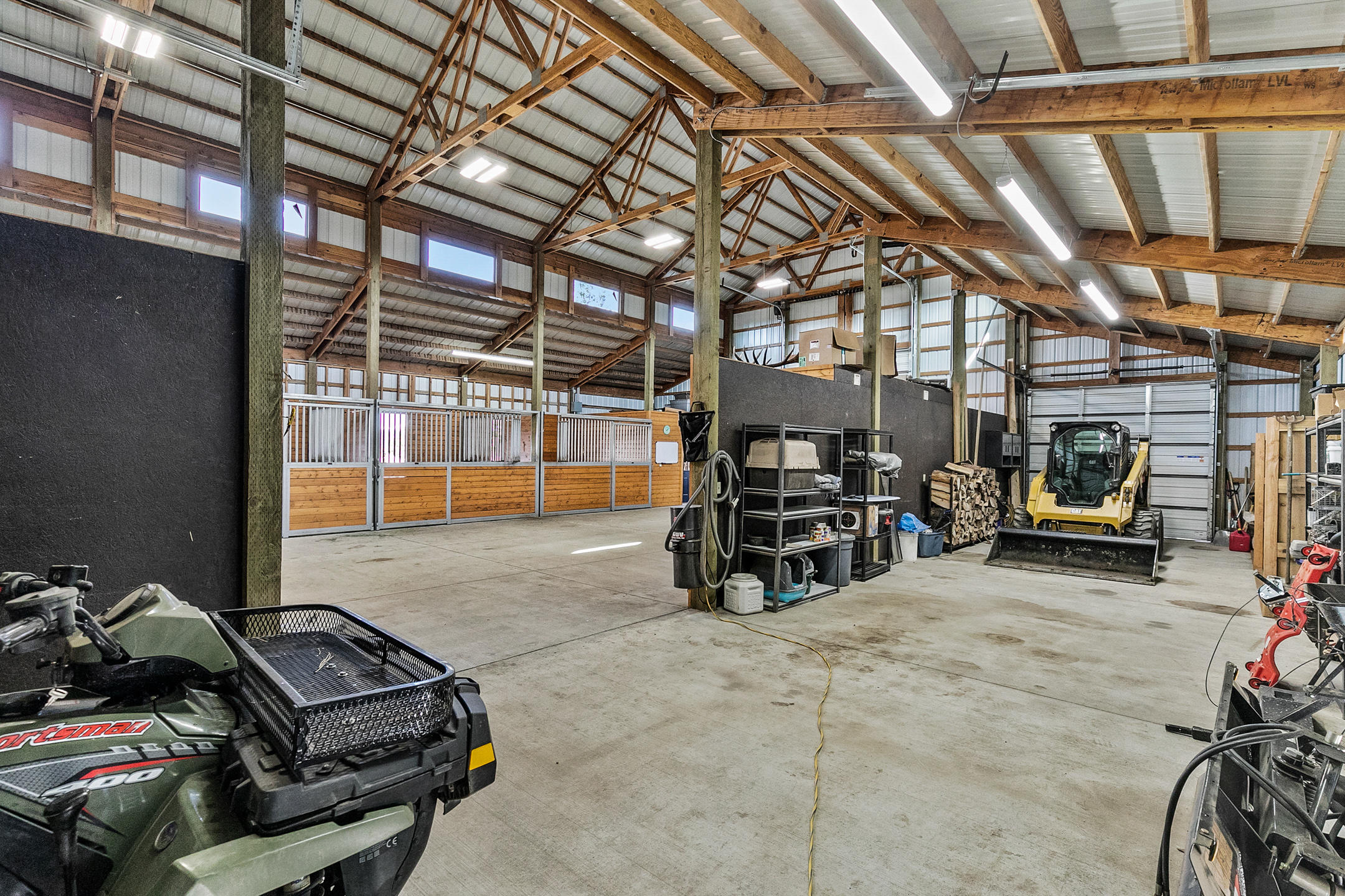 69580 Goodrich Road Sisters, OR 97759 - Photo 35 of 38 RV center aisle in barn with 4 automatic doors and 2 manual roll up doors