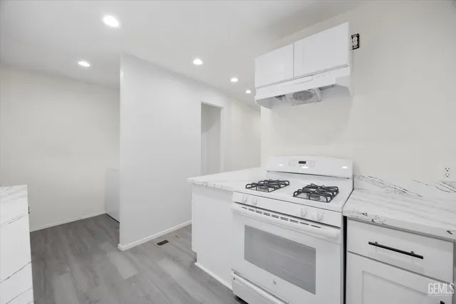 a stove top oven sitting inside of a kitchen