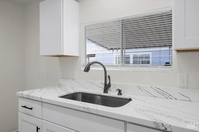 a kitchen with a sink and a wooden floor