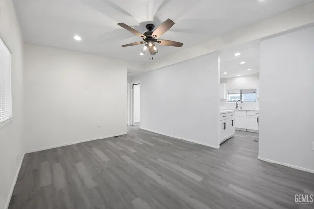 a view of an empty room with a kitchen