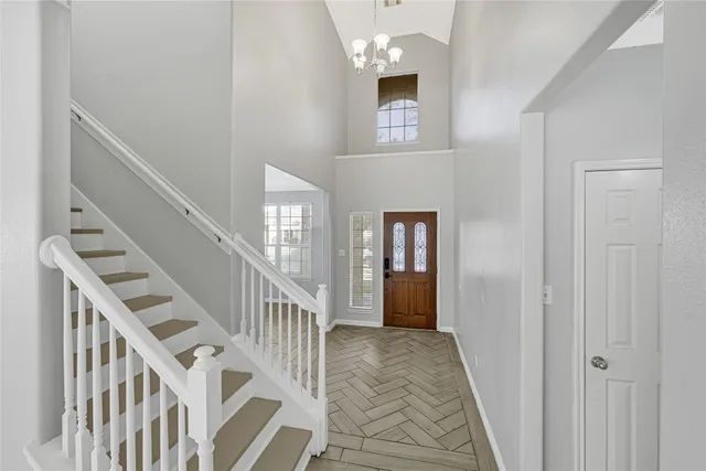 a view of entryway and hall with wooden floor
