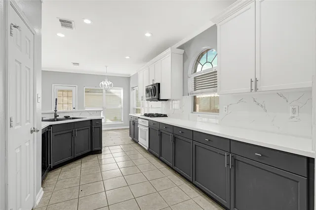 a kitchen with sink a stove and refrigerator