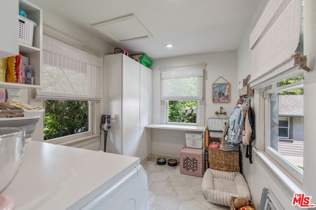 a bathroom with a sink a window and mirror