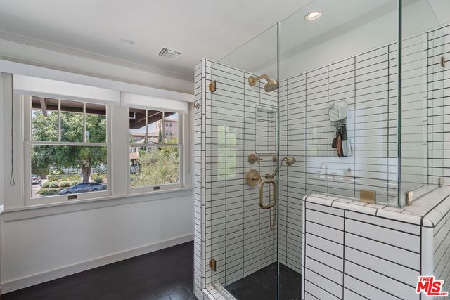 a view of a porch with furniture and floor to ceiling window