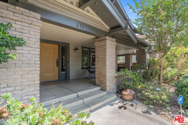 a view of a house with potted plants