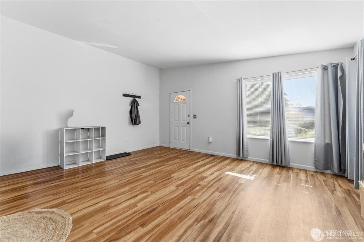 380 North Shore Court Manson, WA 98831 - Photo 11 of 27 a view of a bedroom with wooden floor and windows