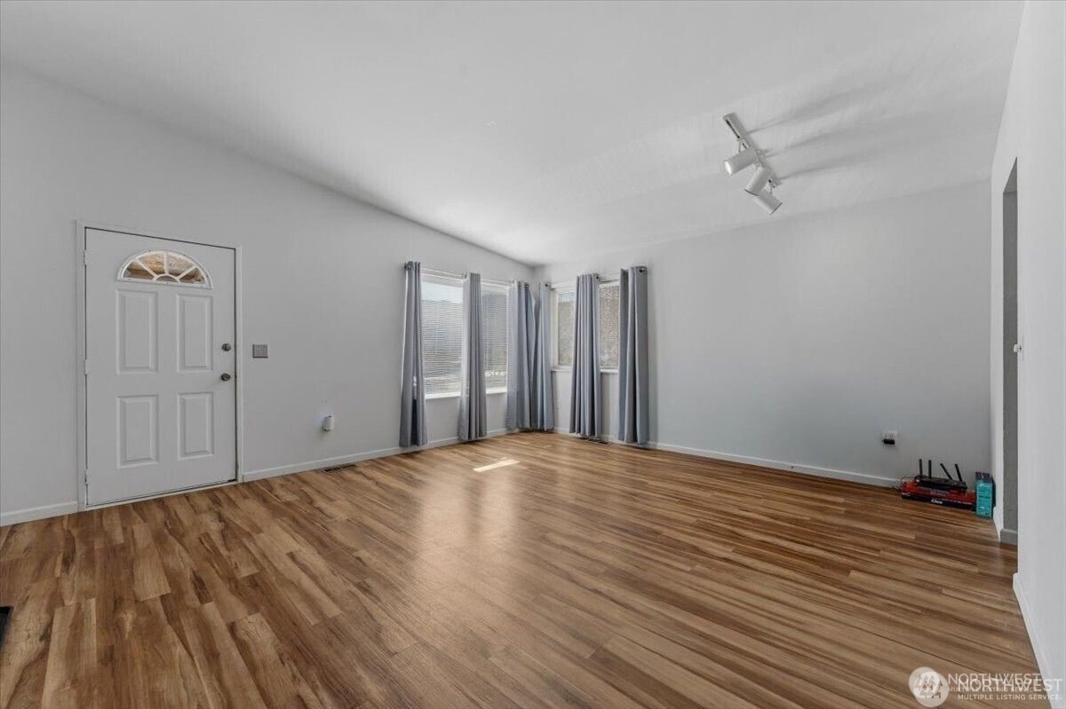 380 North Shore Court Manson, WA 98831 - Photo 9 of 27 a view of an empty room with wooden floor