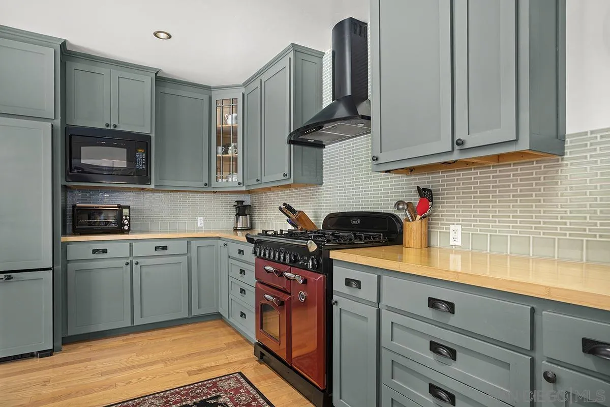 3636 Herbert Street San Diego, CA 92103 - Photo 21 of 55 a kitchen with stainless steel appliances granite countertop a sink a stove and cabinets