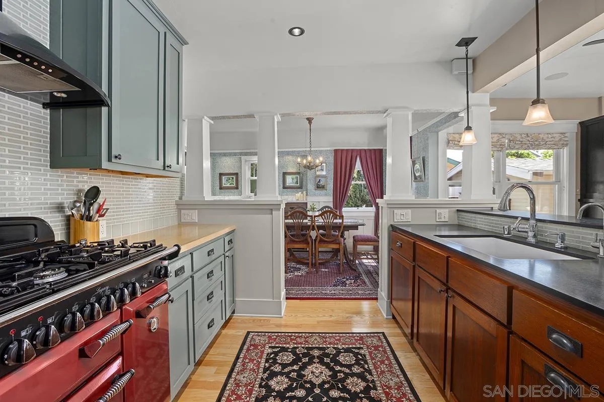 3636 Herbert Street San Diego, CA 92103 - Photo 23 of 55 a kitchen with stainless steel appliances granite countertop a sink stove and cabinets
