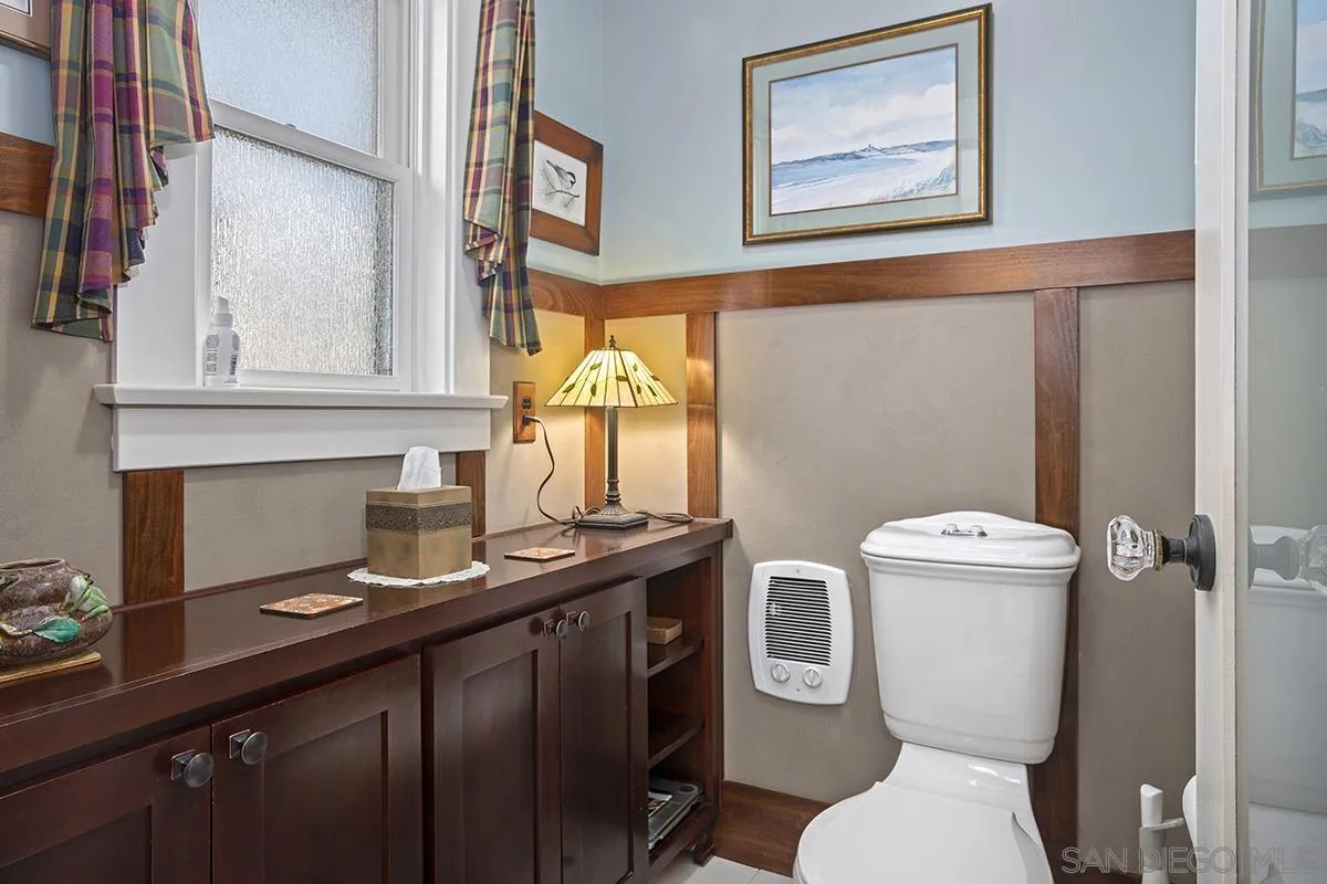 3636 Herbert Street San Diego, CA 92103 - Photo 34 of 55 a bathroom with a toilet sink and mirror