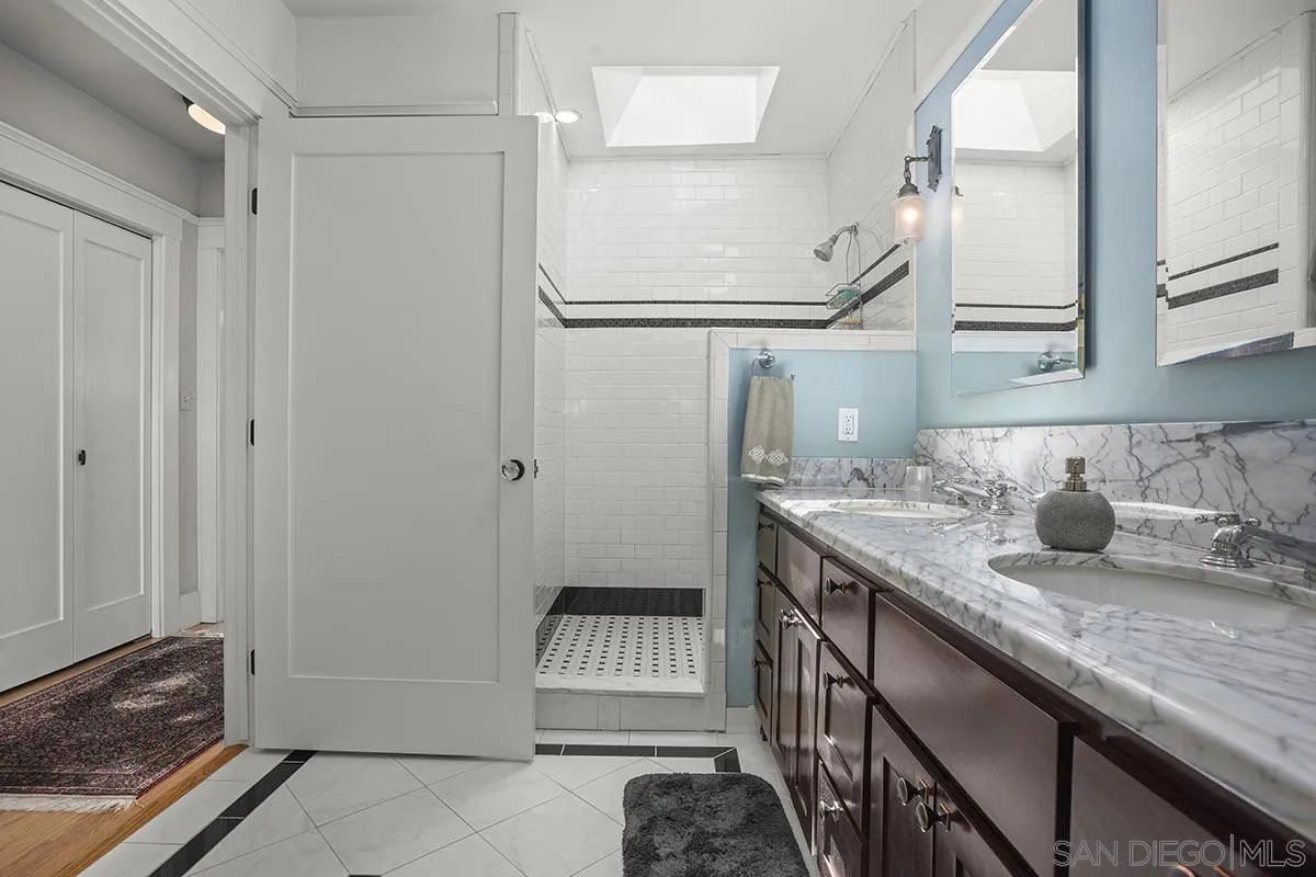 3636 Herbert Street San Diego, CA 92103 - Photo 35 of 55 a bathroom with a granite countertop sink and a mirror