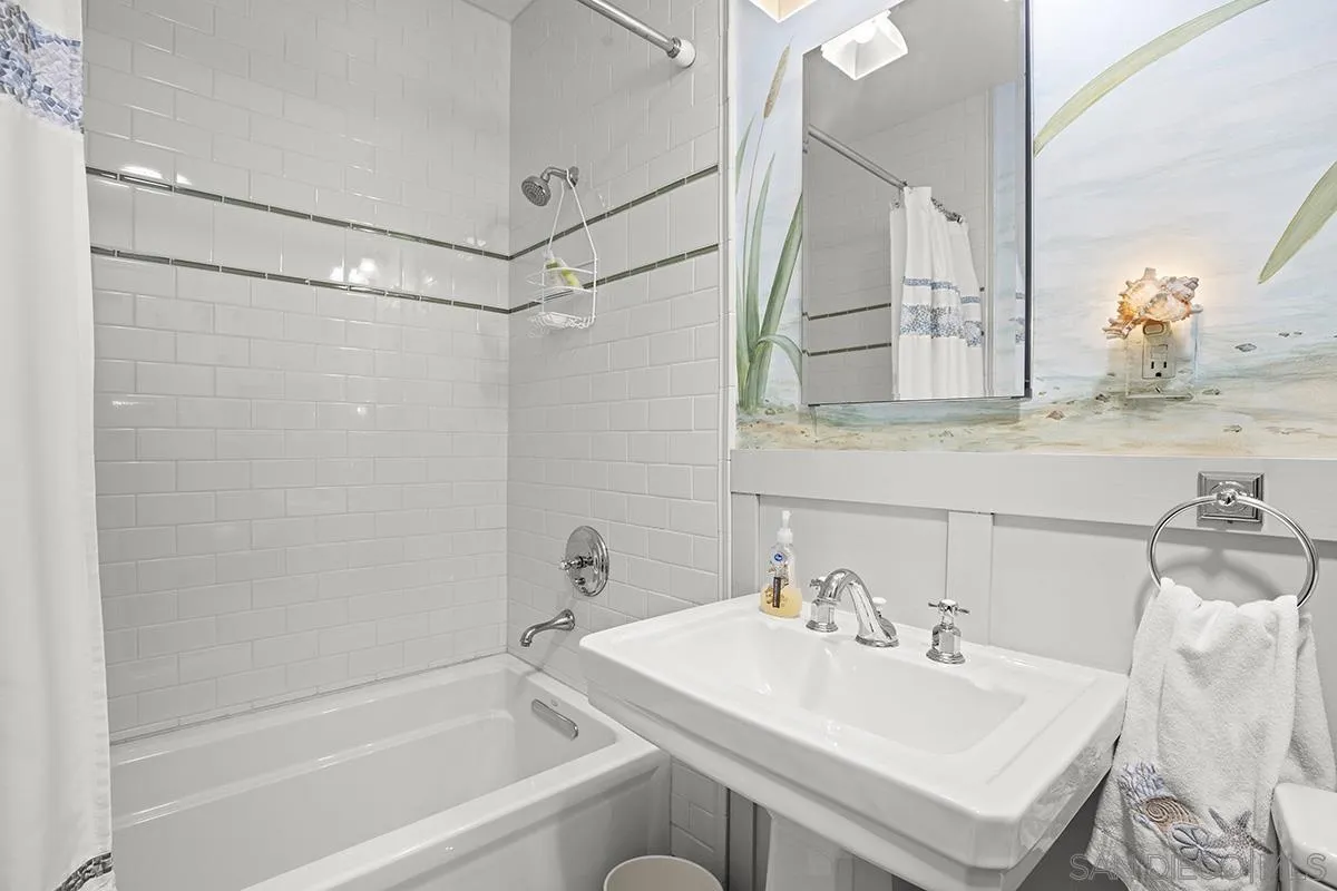 3636 Herbert Street San Diego, CA 92103 - Photo 41 of 55 a bathroom with a sink mirror and a bathtub