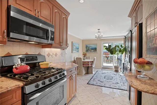 a kitchen with stainless steel appliances granite countertop a stove and a microwave