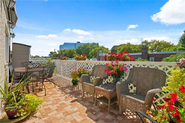 a view of a chairs and table in the backyard