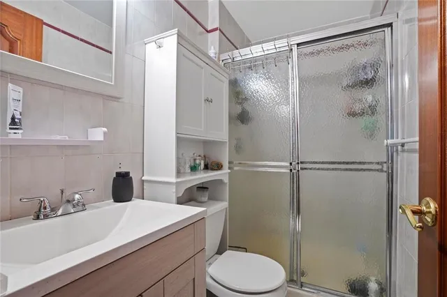 a bathroom with a sink toilet and shower