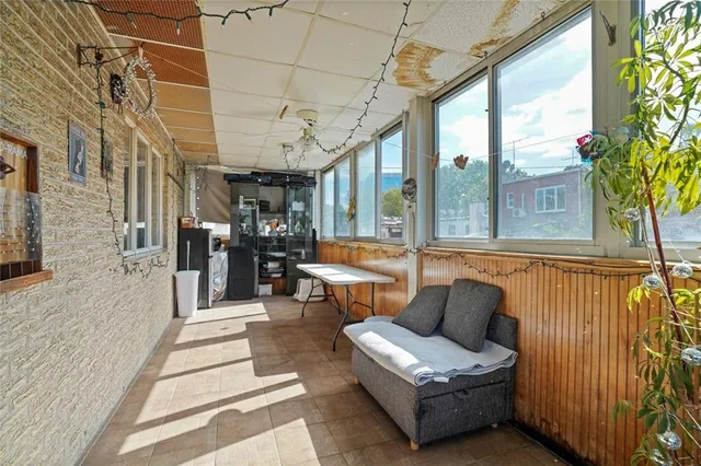 a balcony with furniture and a potted plant