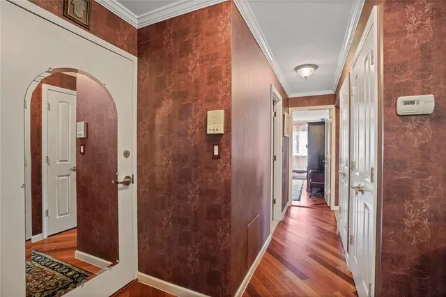 a view of a hallway with wooden floor
