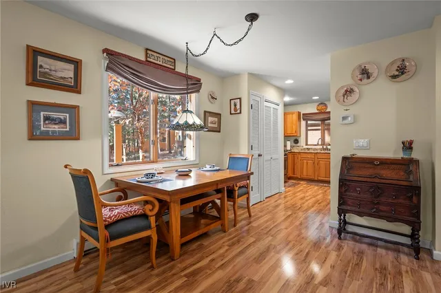 a room with a wooden table and chairs