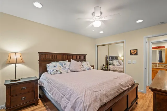 a bedroom with a bed and lamp on dresser