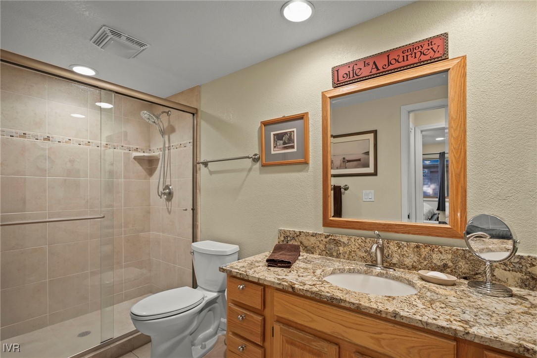 939 Incline Way, Unit 221 Incline Village, NV 89451 - Photo 16 of 20 a bathroom with a granite countertop sink toilet and shower
