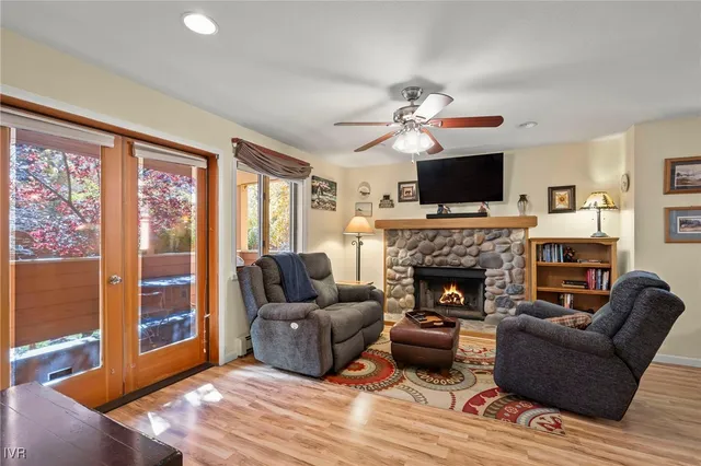 a living room with furniture a flat screen tv and a fireplace