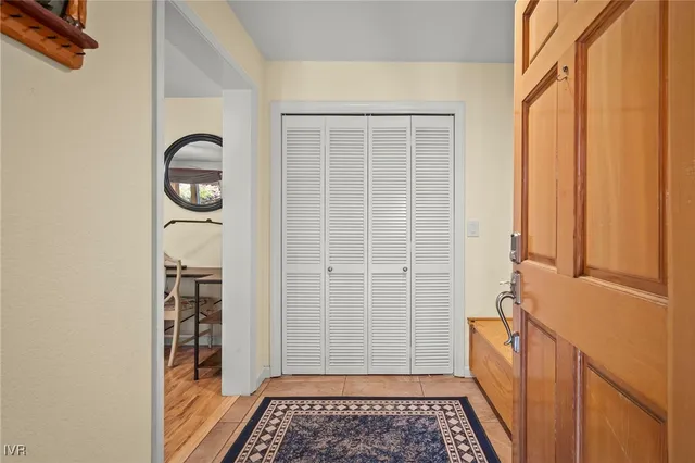 a view of a closet area with wooden floor