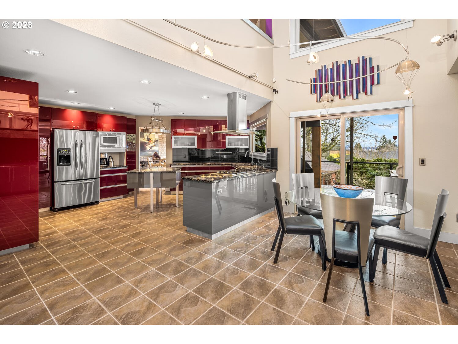 822 Southeast Morgan Road Vancouver, WA 98664 - Photo 7 of 32 a open kitchen with stainless steel appliances kitchen island granite countertop a table chairs and a refrigerator