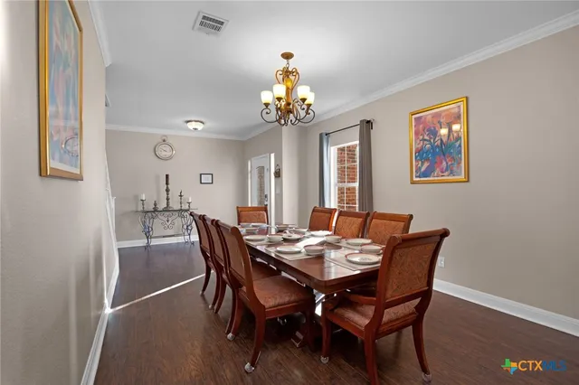 a kitchen with kitchen island white cabinets and refrigerator