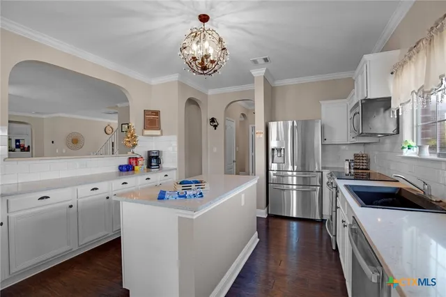 a kitchen with a sink stove and microwave