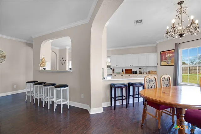 a bedroom with furniture and a large window