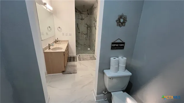a bathroom with a sink a mirror and shower