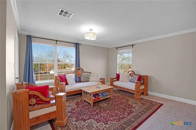 a living room with furniture and pool table