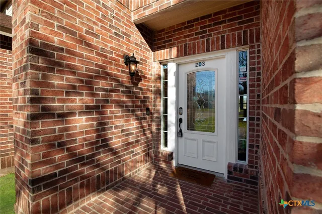a view of a brick house with many windows