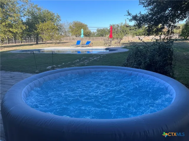 a view of a table and chairs in the garden