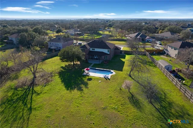 an aerial view of a house with a yard
