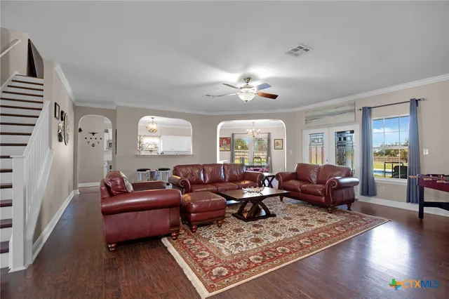 a living room with furniture and wooden floor